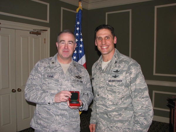 Brig. Gen. Richard D. Evans III, USAF (l), mobilization assistant to the director, global operation, U.S. Strategic Command, joins together with Col. Donovan L. Routsis, USAF, chapter president. Gen. Evans spoke to the general membership about Joint Electromagnetic Spectrum Operations at the January luncheon.